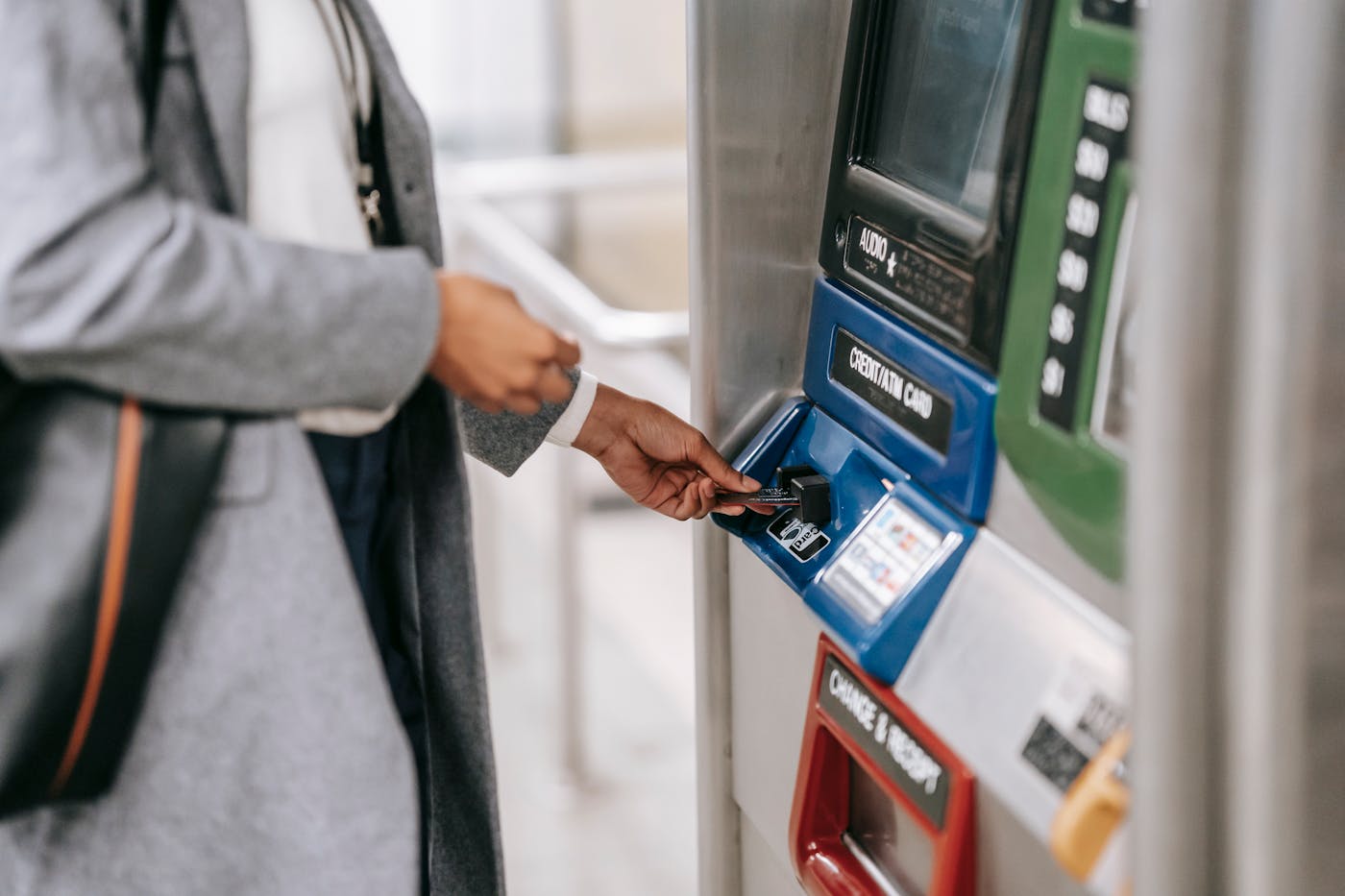 Traveler using a ticket or payment machine in a subway station