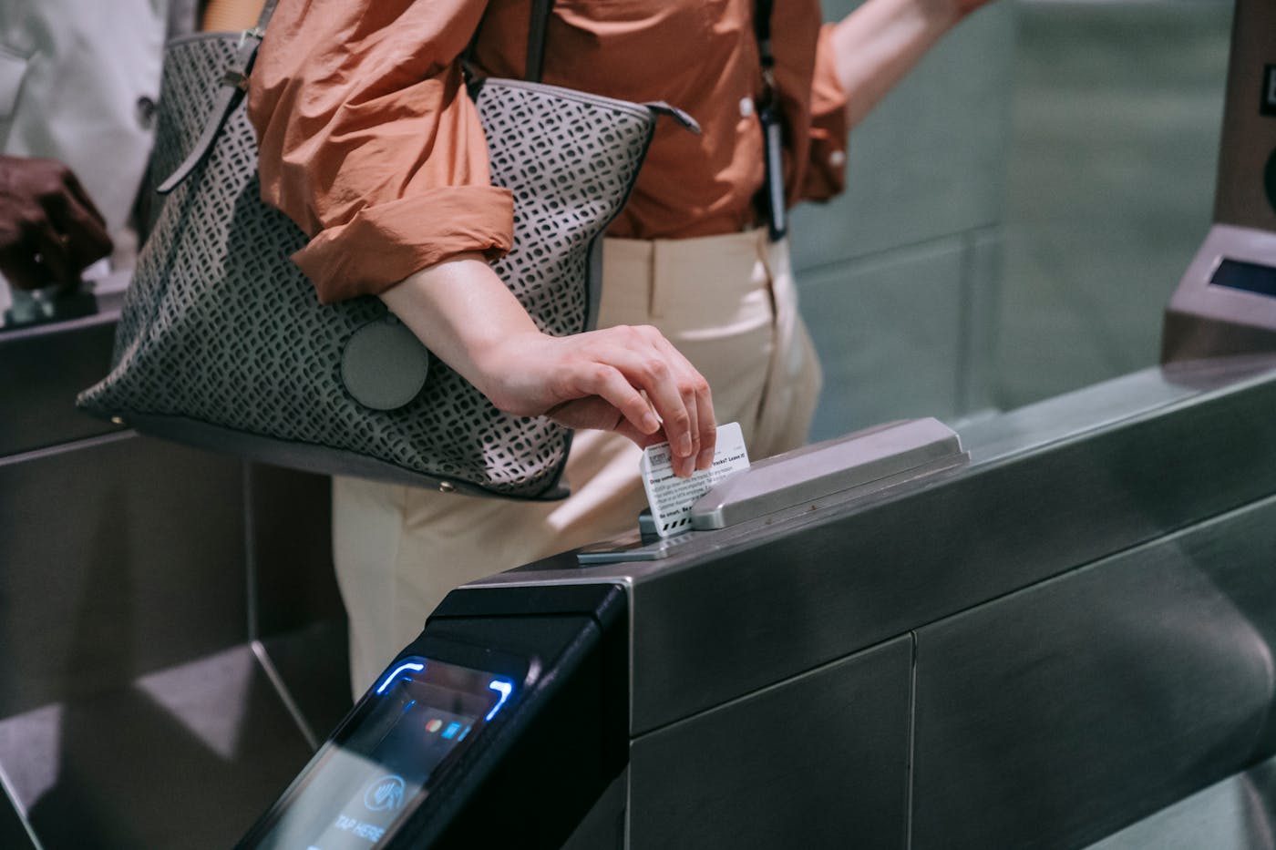 Traveler using a card at a subway turnstile